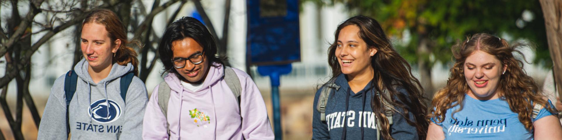 Penn State Altoona students walking along the campus reflecting pond.